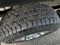 A close-up of a rugged tire from a 2017 GMC Sierra 1500 featuring an aggressive tread pattern ideal for off-road driving