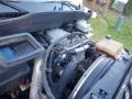 Close-up view of the engine compartment of a 2014 International Durastar showing various components including hoses and a coolant reservoir