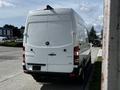 A 2017 Mercedes-Benz Sprinter van with a white exterior parked with its rear facing the viewer