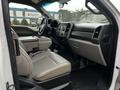 Interior view of a 2019 Ford F-550 featuring leather seats and a modern dashboard with controls and display screens