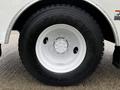 A close-up of a black Goodyear tire mounted on a white wheel of a 2013 International DuraStar truck