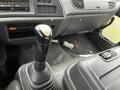 Interior of a 2006 GMC F7B042 featuring a gear shift lever and dashboard controls