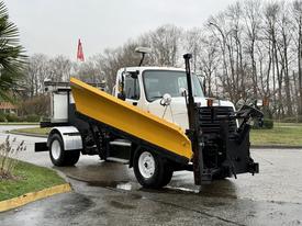 A 2016 Freightliner 108SD truck with a yellow snow plow attached to the front positioned at an angle