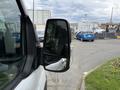 A 2022 Ford Transit van with a side mirror visible in the foreground