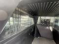 Interior of a vehicle with a metal partition and perforated walls designed for security and containment purposes