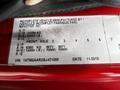 A vehicle specification label from a 2011 International 4400 showing details like weight, axle information, and vehicle identification number