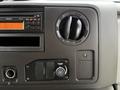Dash console of a 2014 Ford E-450 featuring a radio display an air vent and temperature controls