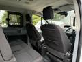 Interior view of a 2017 Ford Transit T150 XLT showing two front seats and two rear seats with fabric upholstery and headrests