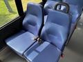 Two blue fabric seats with seatbelts in a 2020 Chevrolet Express interior