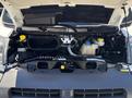 Engine compartment of a 2016 RAM Promaster showing the engine components including hoses reservoirs and battery