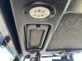 Interior view of a Kubota F3990 with a circular light fixture above a textured surface and a panel below it