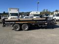 2024 Southland 18 Foot Dump Trailer with dual axles and a black exterior showing a loading bed designed for transporting materials