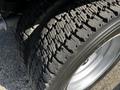 Close-up of a used tire from a 2016 Ford F-550 showing significant wear with visible tread patterns and signs of aging