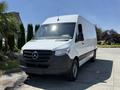 A 2019 Mercedes-Benz Sprinter van with a white exterior and black front grille parked in a residential area
