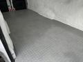 A 2017 Ford Transit interior with a silver diamond plate floor and no cargo visible in the back compartment