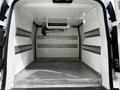 A 2019 Ford Transit Connect van interior showing a spacious cargo area with silver metal shelving and a mounted air conditioning unit on the ceiling