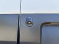 Detail of a rear door latch on a 2016 Ford Transit showcasing the locking mechanism and textured surface of the vehicle's exterior