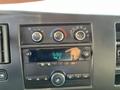 Dashboard controls and radio display of a 2014 Chevrolet Express showing time and FM frequency settings