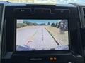 A digital rearview camera display showing a 2020 Ford F-350 SD backing up with guiding lines on the screen