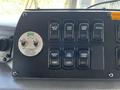 Control panel of a 2006 Emergency One Fire Truck featuring various buttons for operational functions and a rotary switch for warnings