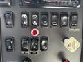 Control panel of a 2012 Freightliner M2 112 featuring various switches including those for work lights and PTO