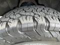 A close-up of a rugged tire tread on a 2016 Chevrolet Tahoe showcasing deep grooves and a strong design suitable for off-road driving