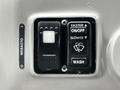 Control panel for a 2015 Spartan School Bus featuring buttons for faster slower wash and on off functions with a webasto label