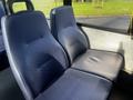 Two blue patterned seats in the interior of a 2018 Chevrolet Express van