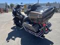 A 2004 Harley-Davidson FLHTCUI motorcycle with a shiny gold and black finish featuring a touring-style seat and saddlebags and chrome accents