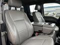 Interior of a 2019 Ford F-550 featuring two leather front seats with a center console and cup holders between them