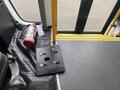 The interior of a 2017 Chevrolet Express showing a fire extinguisher and a metal plate with several bolt holes on the floor near the entrance