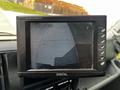 Screen displaying a rearview camera feed from a 2018 Hino 195 showing a view of a surface and surroundings behind the vehicle