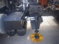 Close-up of a 2016 International WorkStar 7500 showcasing hydraulic components and a yellow rotating attachment at the front