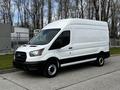 A white 2020 Ford Transit van with a high roof and black accents parked with its side facing the viewer