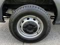 A close-up of a black tire mounted on a metallic wheel, showing the tread pattern and the Ford logo on the hubcap of a 2018 Ford Transit