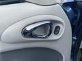 Close-up of the interior door handle and locking control of a 2007 Chrysler PT Cruiser