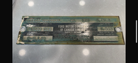 A metal data plate for a 1962 Ford F-100 detailing specifications including serial number, engine, transmission, axle ratio, weight, and manufacturing information