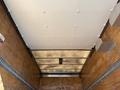 Interior view of a 2014 Hino 195 truck with a flat ceiling and reinforced paneling in a cargo area
