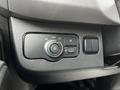 A control panel in a 2020 Mercedes-Benz Sprinter featuring a circular dial for auto lighting and additional buttons for headlights and other controls