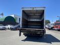 A 2015 Ford F-450 SD truck with an empty cargo area visible from the rear