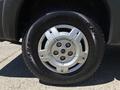 Close-up of a silver alloy wheel with six spokes and a black tire featuring the name Antares on the sidewall