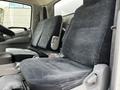Two upholstered front seats of a 2018 Hino 195 truck with a patterned fabric design and a central console between them