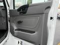 The door panel of a 2020 International MV607 featuring a built-in handle and armrest in a simple gray design