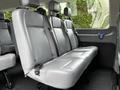 Interior seating of a 2017 Ford Transit 350 featuring gray upholstery with three rows of seats each equipped with seatbelts