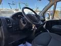 Interior of a 2016 RAM Promaster showing the dashboard steering wheel and front seats with various controls and keys visible