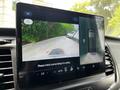 A touchscreen display in a vehicle showing a rearview camera view of a 2022 Ford Transit with guidelines for parking and a view of the vehicle's rear