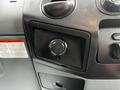 Close-up view of the dashboard of a 2011 Ford F-550 featuring a 12V power outlet and various control knobs
