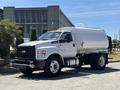 A 2019 Ford F-750 truck with a white exterior equipped with a large tank in the back designed for carrying liquids or materials