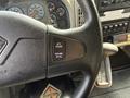 Close-up of the steering wheel of a 2011 International 4300 featuring control buttons for cruise settings including set resume and accelerate