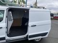 A 2017 Ford Transit Connect van with an open side door revealing the interior cargo space and a metal rack on top